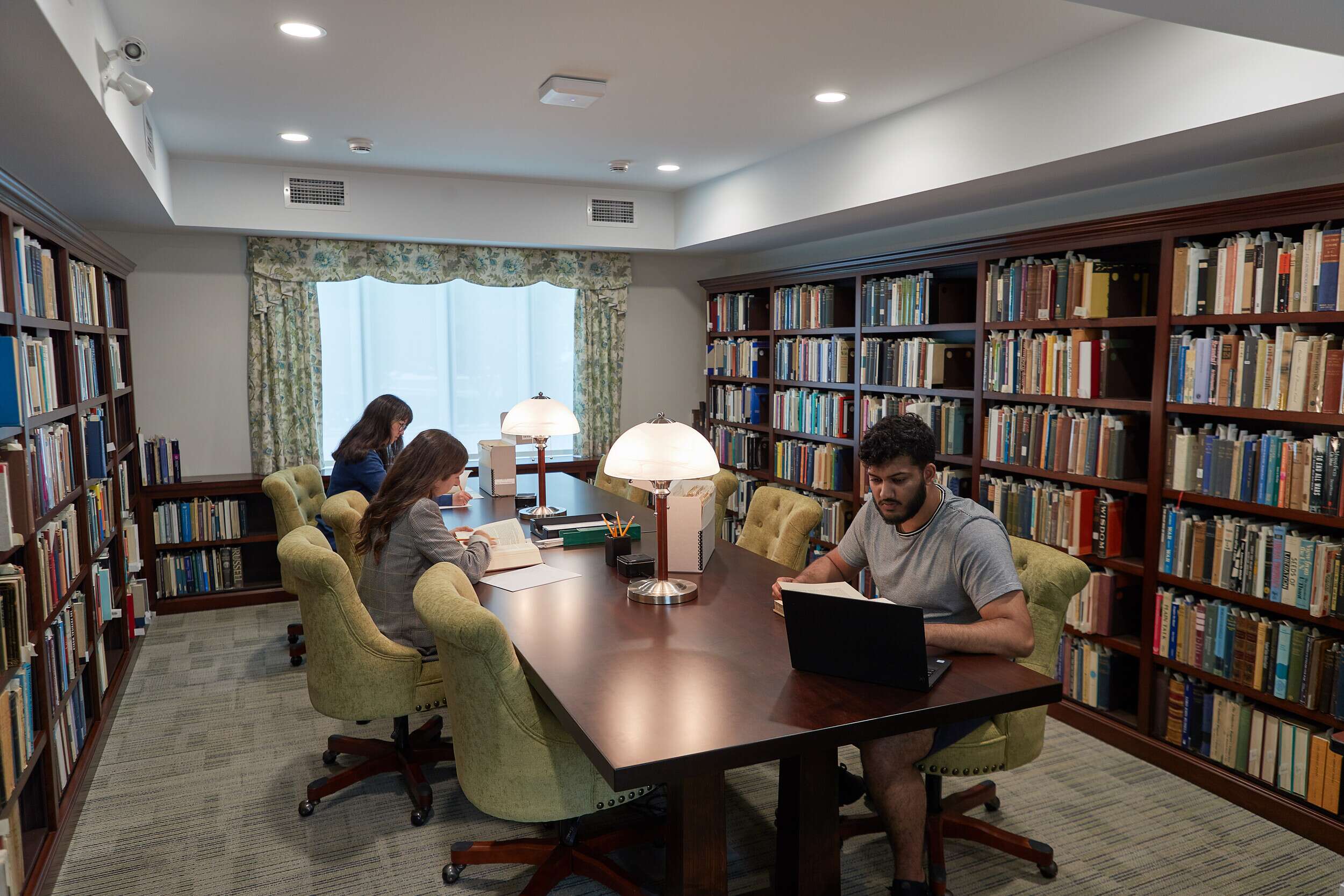 Researchers working in a study room with books, a Bertrand Russell Archives