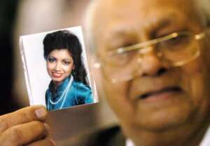 In this 2005 photo, Rattan Singh Kalsi shows a photograph of his daughter, Indira, at a meeting with families of the victims of the 1985 Air India bombing. Photo by Aaron Harris