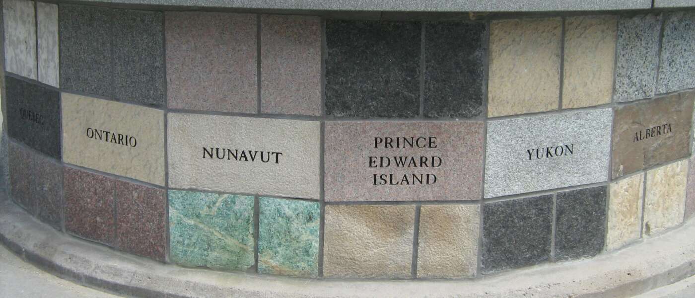 Shows some provinces (Quebec, Ontario, Nunavut, Prince Edward Island, Yukon, Alberta) carved into the stone to which passengers belonged.