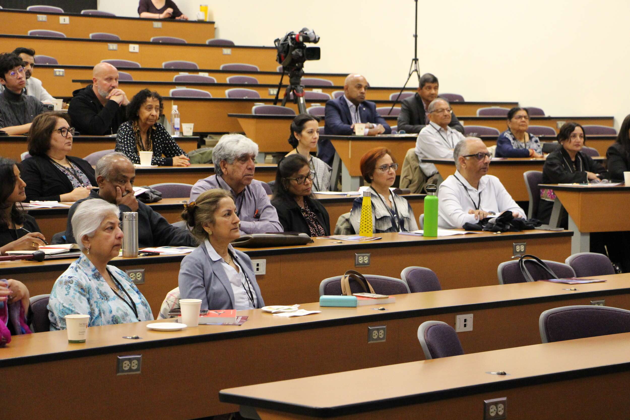 Conference attendees listen to panel presentations during the conference.