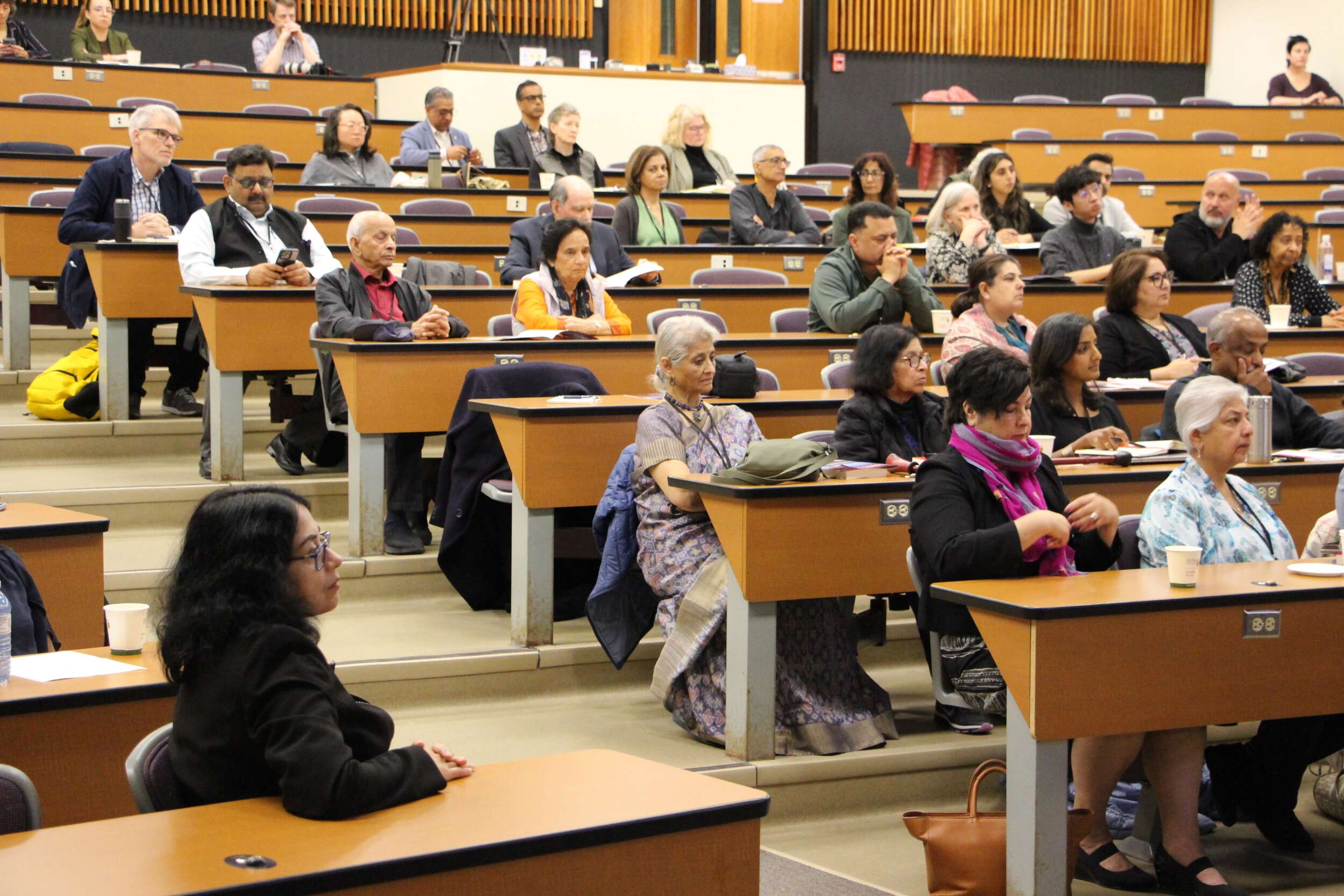 Conference attendees listen to panel presentations during the conference.