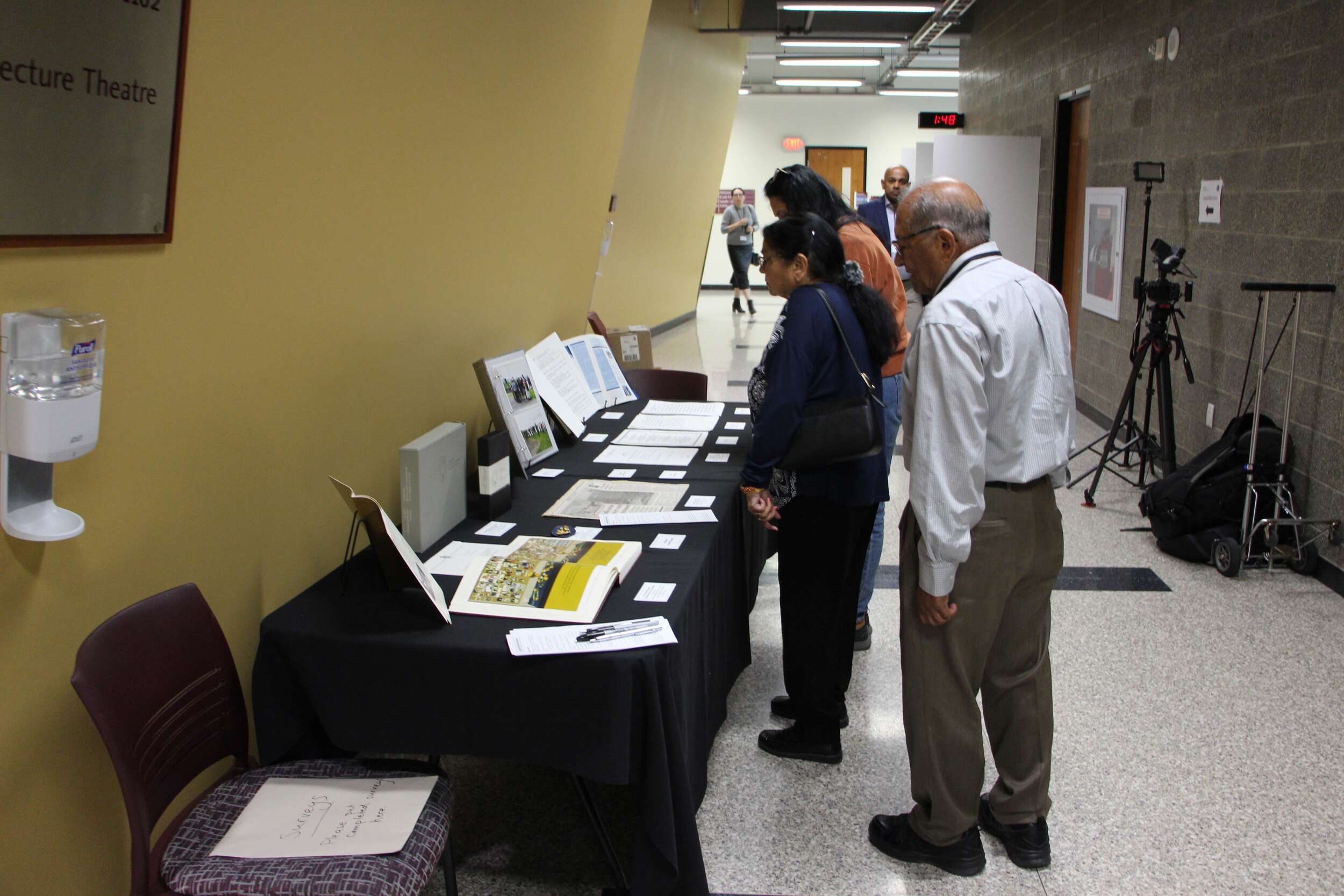 Conference attendees look at the Air India Flight 182 Archive physical exhibit, featuring a selection of donated materials.