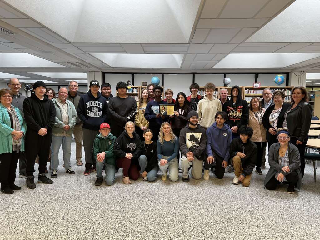 Students and alumni gather for a photo at R.D. Parker Collegiate, Thompson, Manitoba, following a talk about the Air India Flight 182 bombing in honour of classmate and victim Rahul Aggarwal.